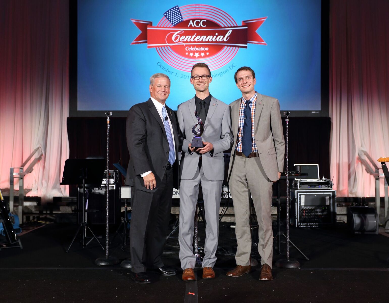 Virtual Construction App Developer Ryan Haines (center) and Sr. Virtual Construction Engineer Eric Cylwik (right) accept the AGC Innovation 3rd-place Award