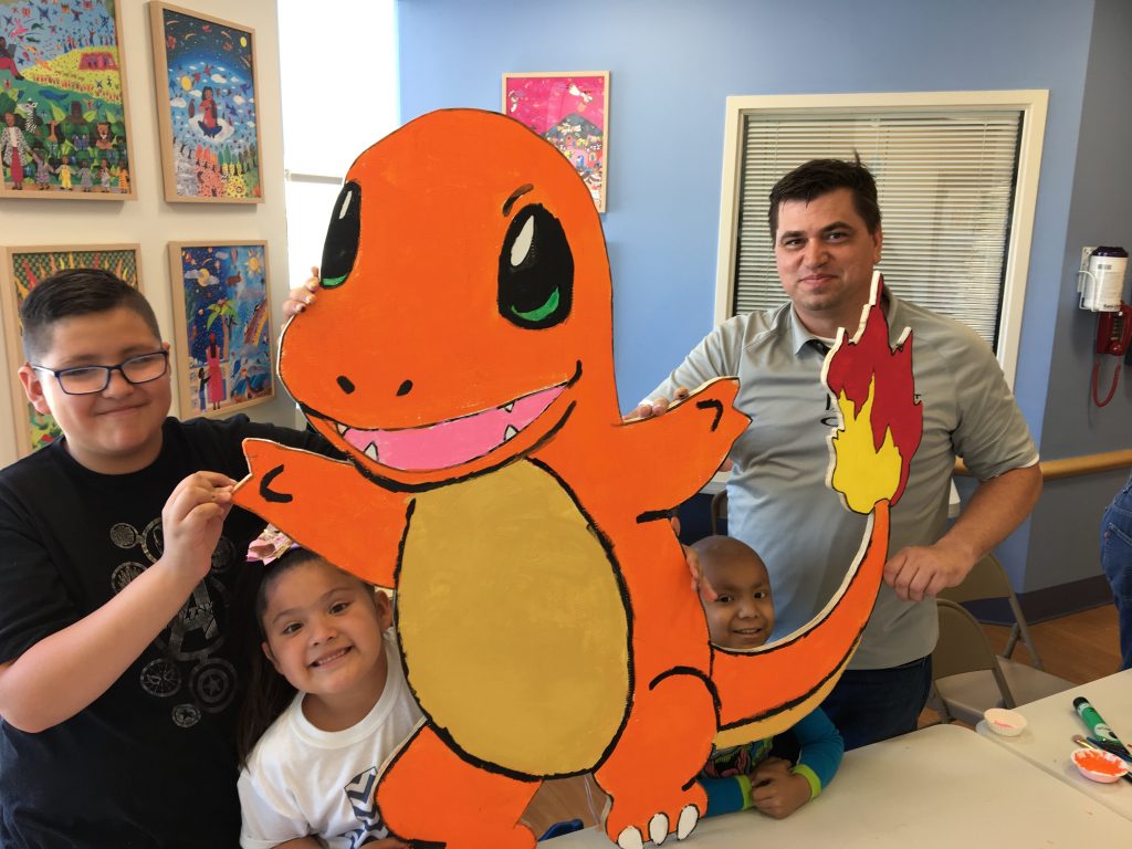 Sundt Project Manager Larry Kurtz and El Paso Children’s Hospital oncology patients display their freshly painted Charmander