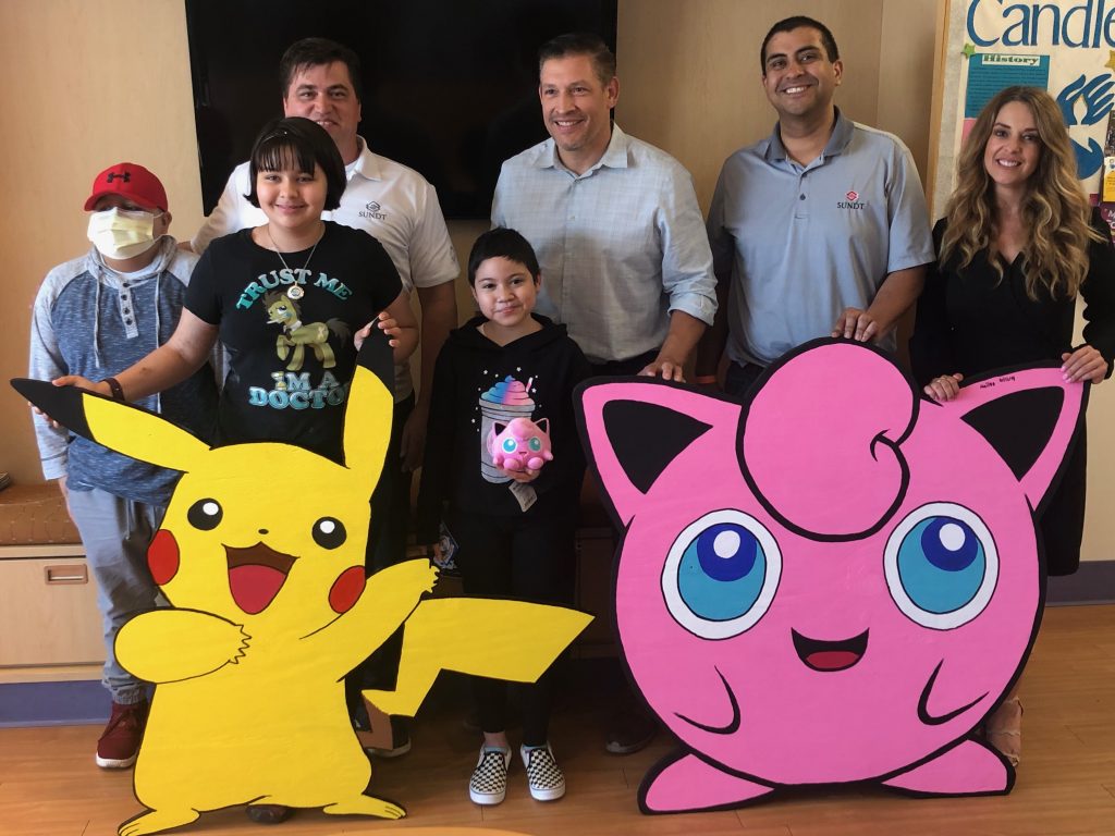 El Paso Children’s Hospital oncology patients pose with Pikachu, Jigglypuff and the Sundt team  