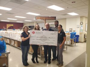 sundt foundation presents a check to mamas kitchen