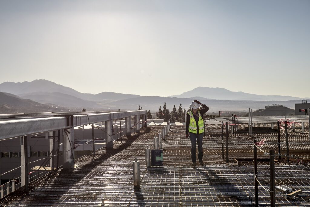 Reese performing a roof inspection on the Center for Global Innovation project at CSU San Bernadino during a windy day