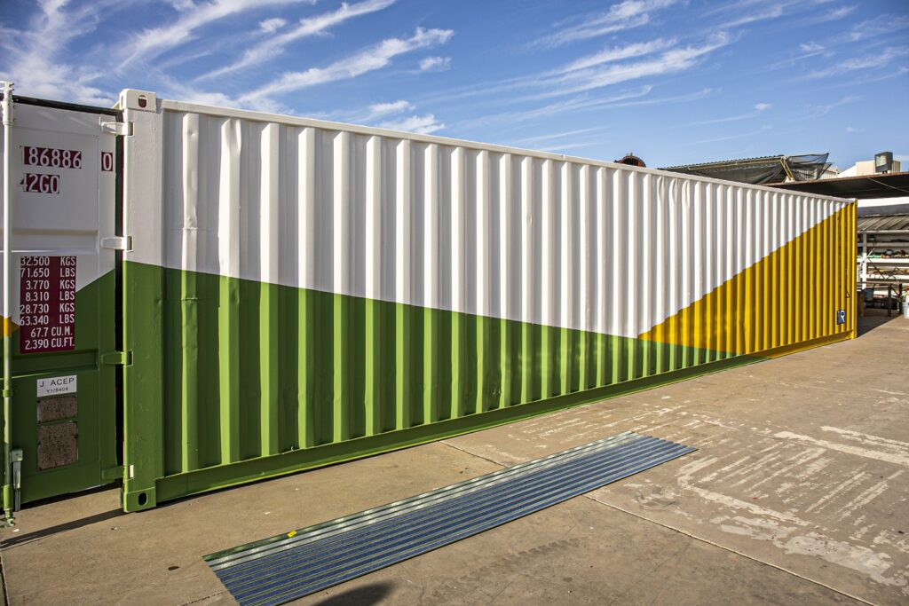 exterior of shipping container painted green and yellow for sustainability