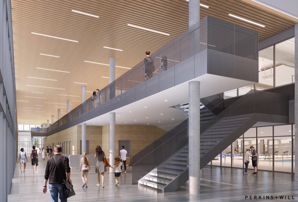 The main entry lobby and mezzanine level with access to natatorium spectator seating and to the fitness center/running track on the gym side. Both the natatorium and community center have goals of LEED Silver certification. 