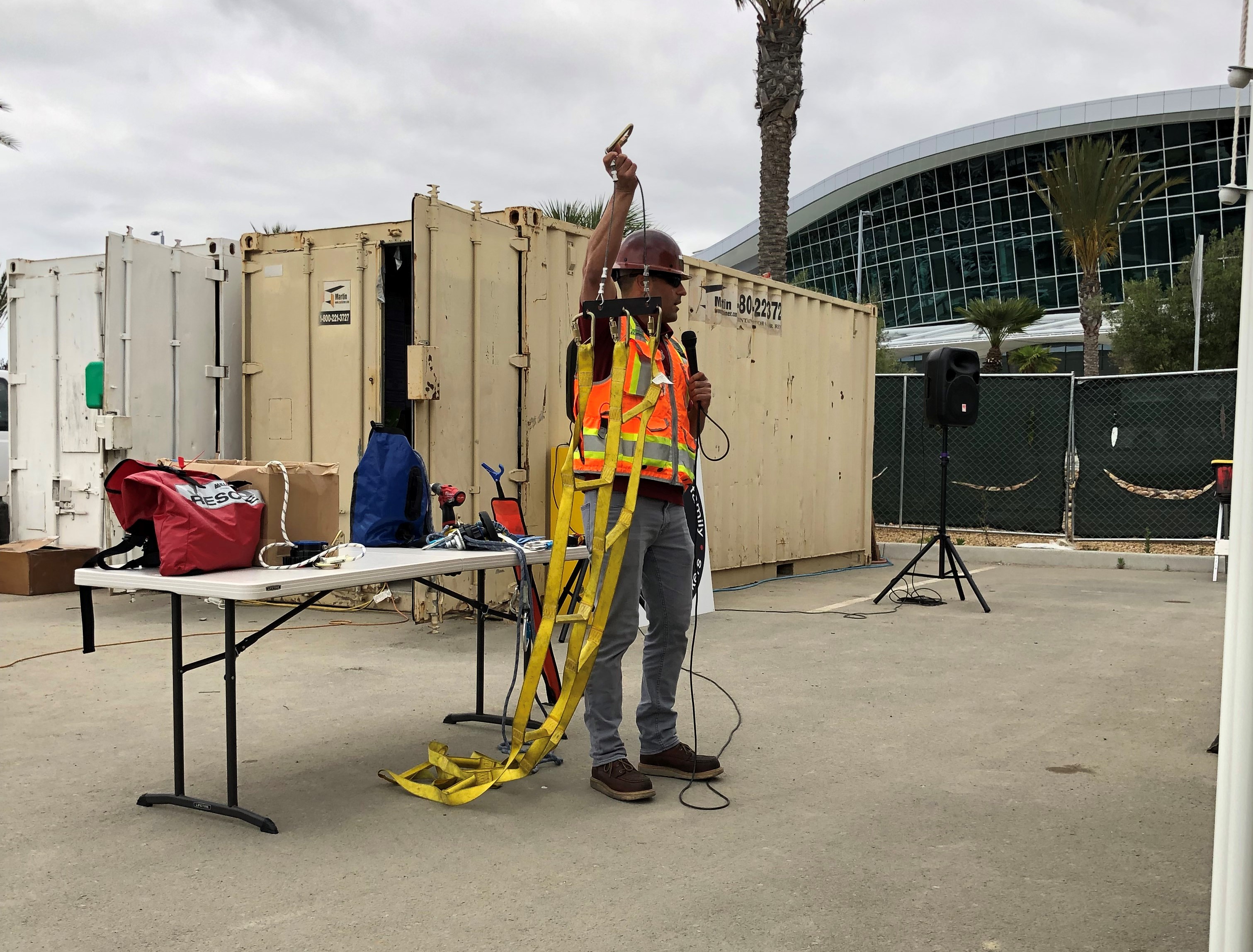 Tony Bonilla de Jobsite Supply, sosteniendo una escalera de rescate con punto de anclaje, le recordó al equipo de Instalaciones de Apoyo Aéreo de San Diego sobre la importancia de la Planificación de Rescate