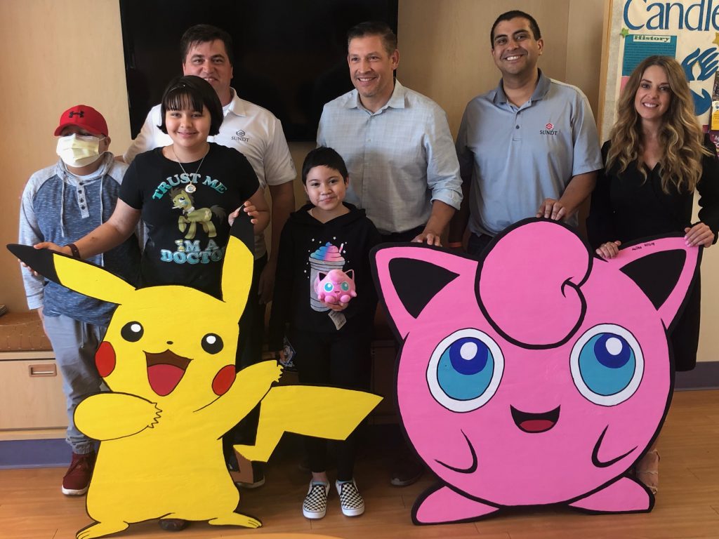 El Paso Children’s Hospital oncology patients pose with Pikachu, Jigglypuff and the Sundt team