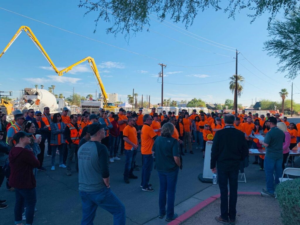 Sundt's Omar Percy gives volunteers an early-morning safety briefing