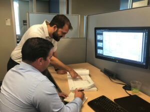 Sundt Industrial Preconstruction Manager Steve Bradford helps a colleague with estimating