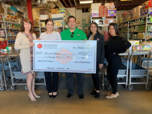 sundt foundation presents check to families forward in their warehouse