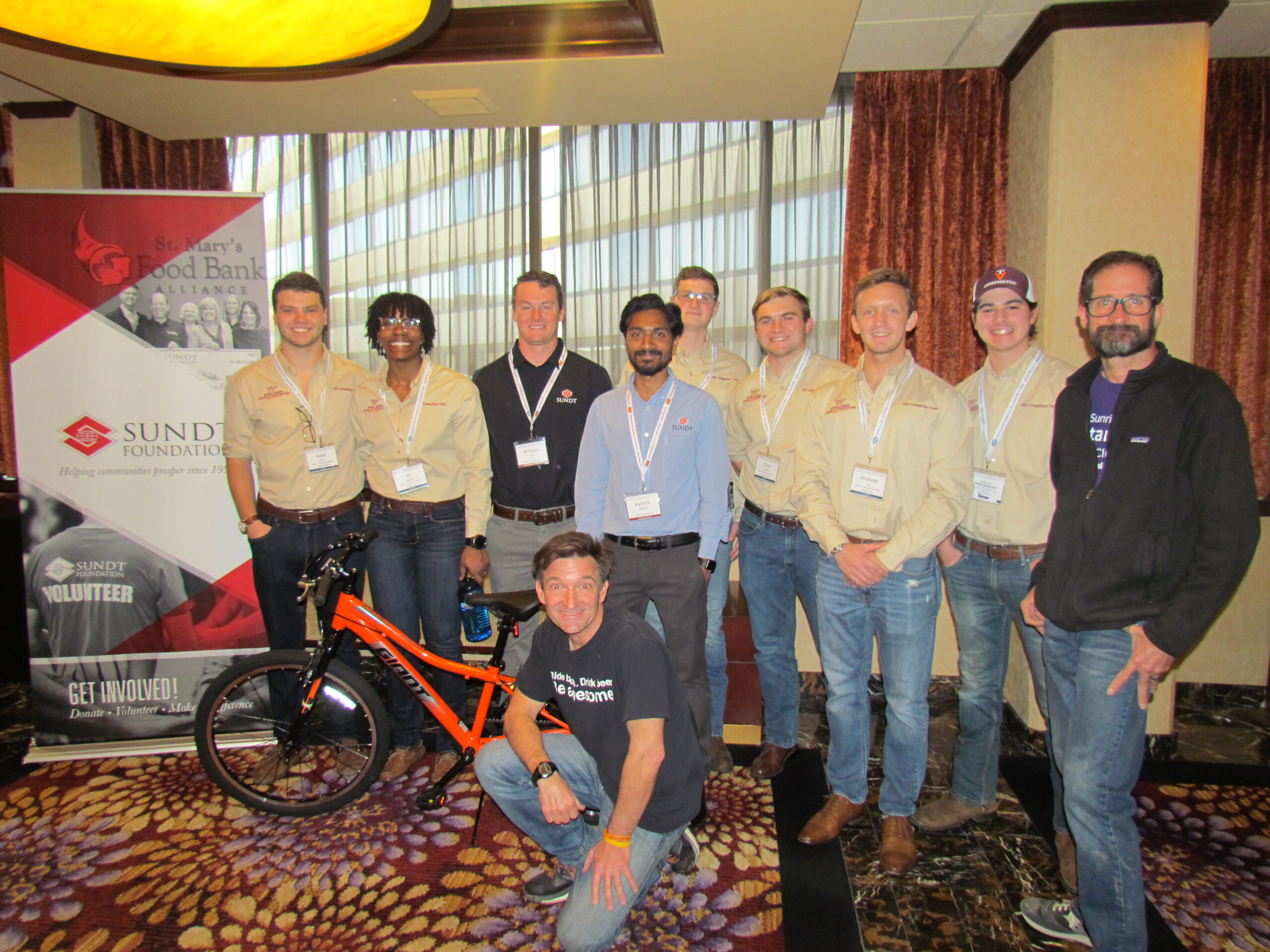 virginia tech students pose with the bike they assembled