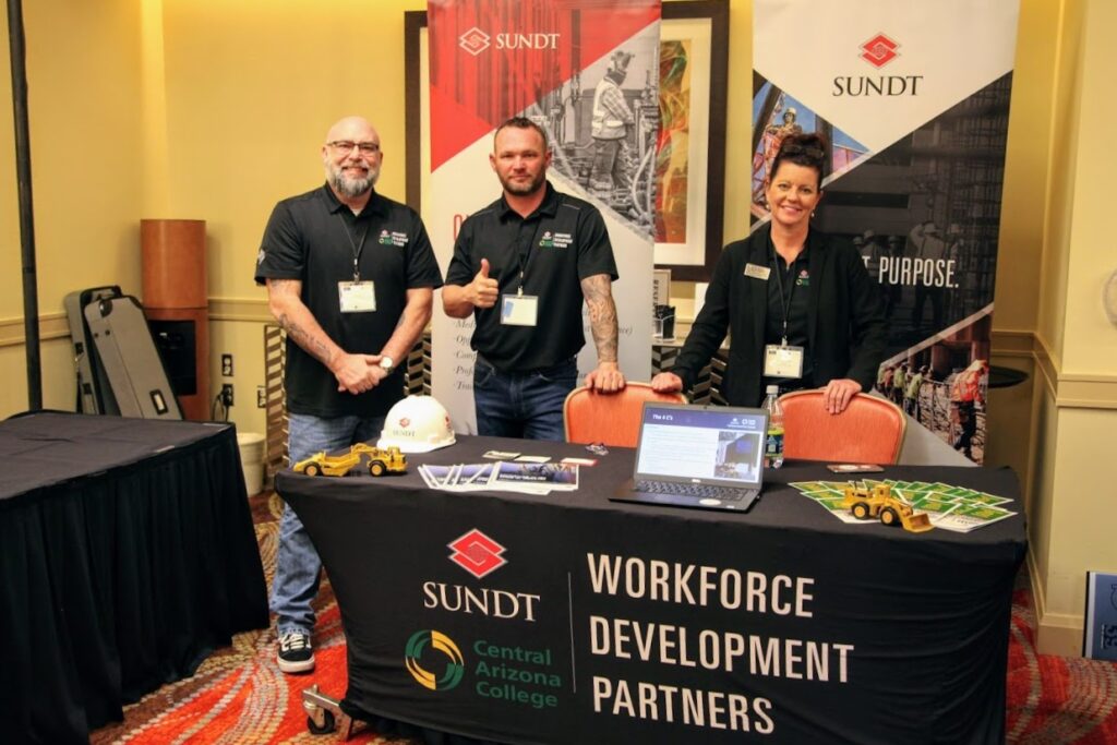 Sean (left) stands with James Busch, CAC Director of Skilled Trades and Workforce Development, and CAC President Dr. Jackie Elliot at a job fair