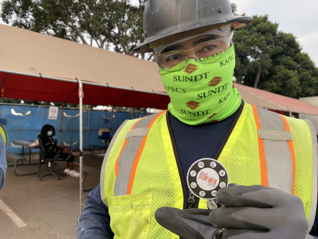 A craft professional displaying his STCKY Week hardhat sticker