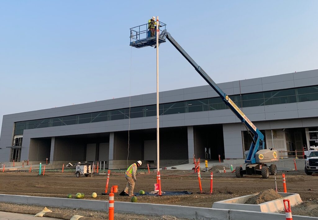 construction workers perform drop test with man lift and watermelons for safety week demo