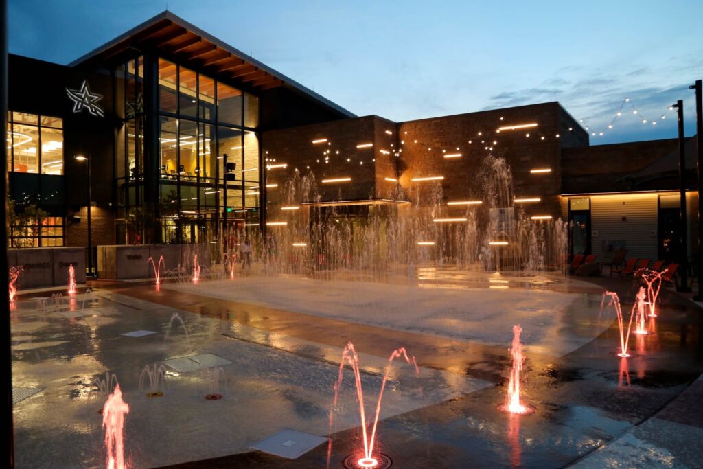 The splash pad outside of the rec center is aglow at dusk