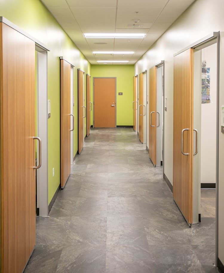 exam rooms at valleywise health care clinic with barn style sliding doors