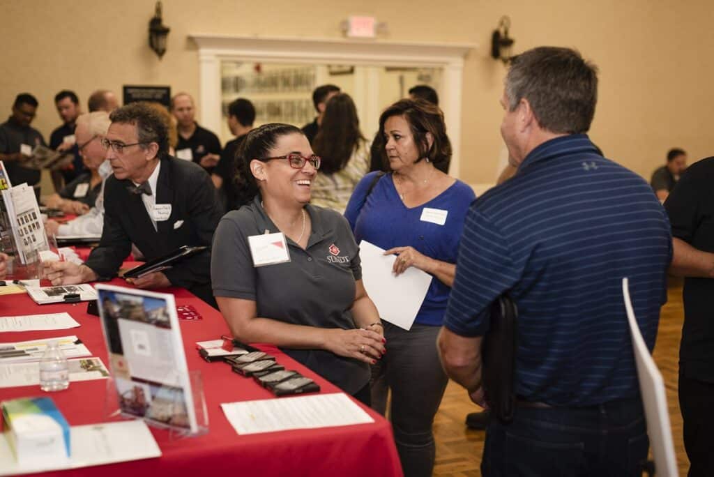 Small Business Coordinator De Anna Andrews meeting with small businesses at a networking event