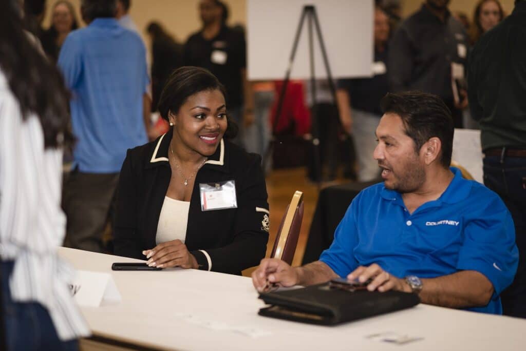 Tracy Sanders Sundt SBLO meets with man who is small business owner at networking event