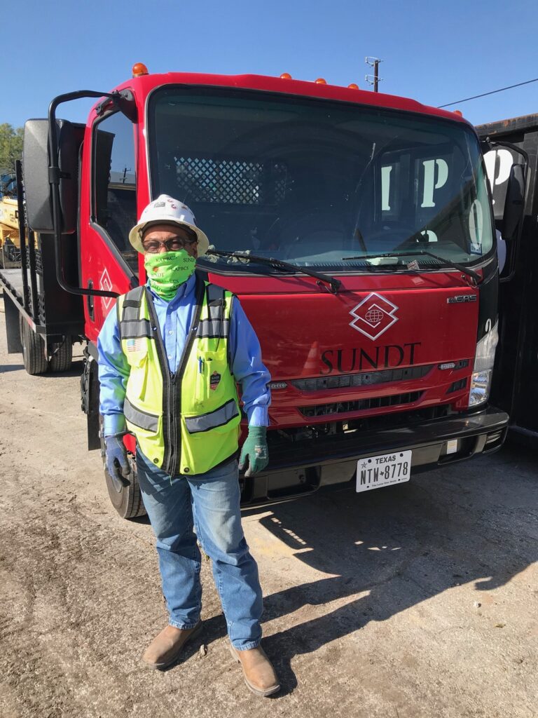 Traffic Control Foreman José Prudente stands in front of his flatbed truck at the San Pedro Creek Project