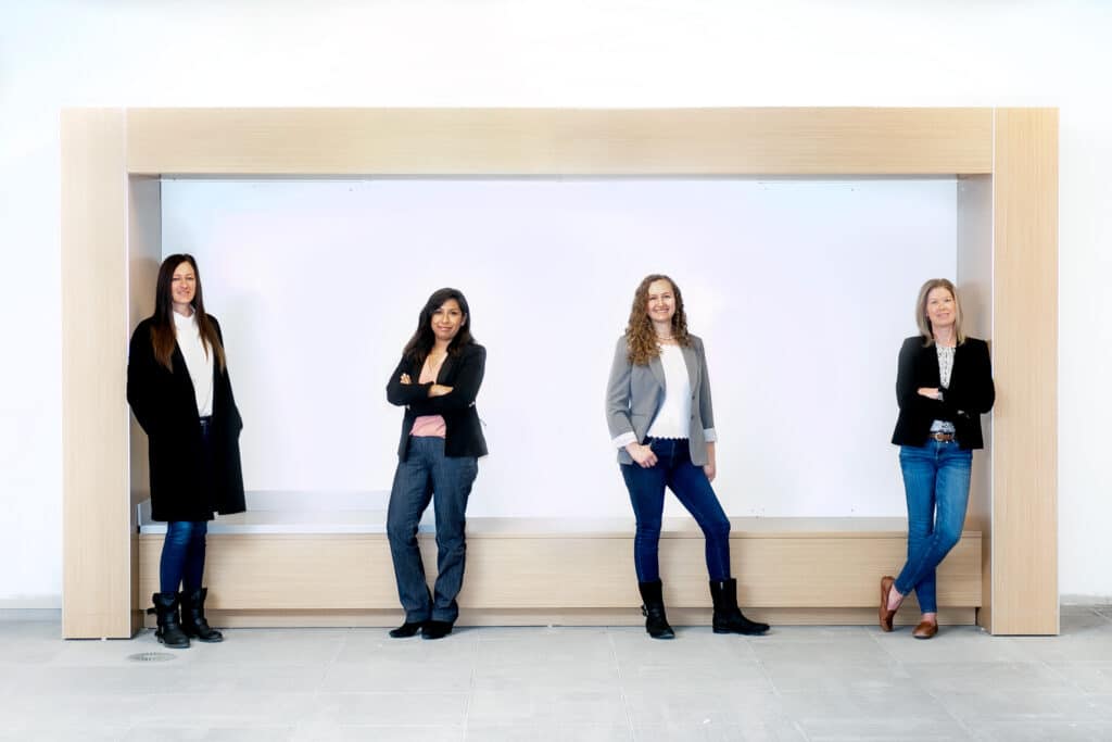 four women pose for professional group photo