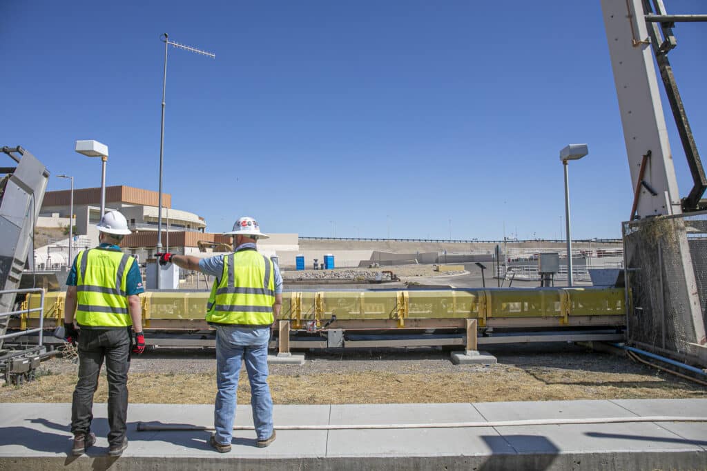 two men discuss design aspects of a water treatment plant