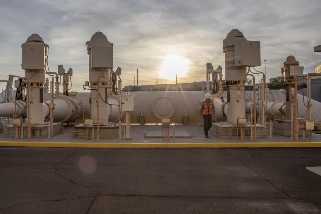 sunrise view of a man walking away from a 220-million-gallon-per-day pump station at a water treatment plant