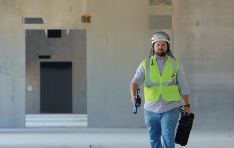 virtual construction engineer Dean Miller carries a skydio autonomous drones and case at a data center construction site