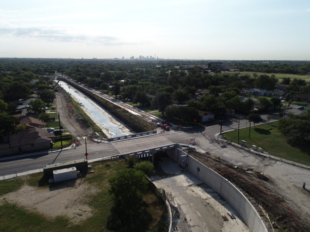 drone view of completed channel slab at seeling channel with downtown San Antonio skyline in background