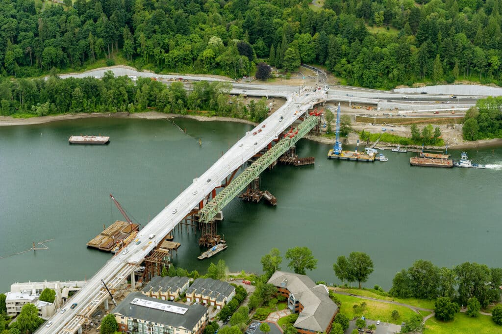 A bridge under construction that spans across a river.