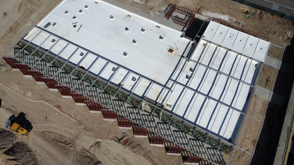 drone shot gives aerial view of roof of data center and IT building