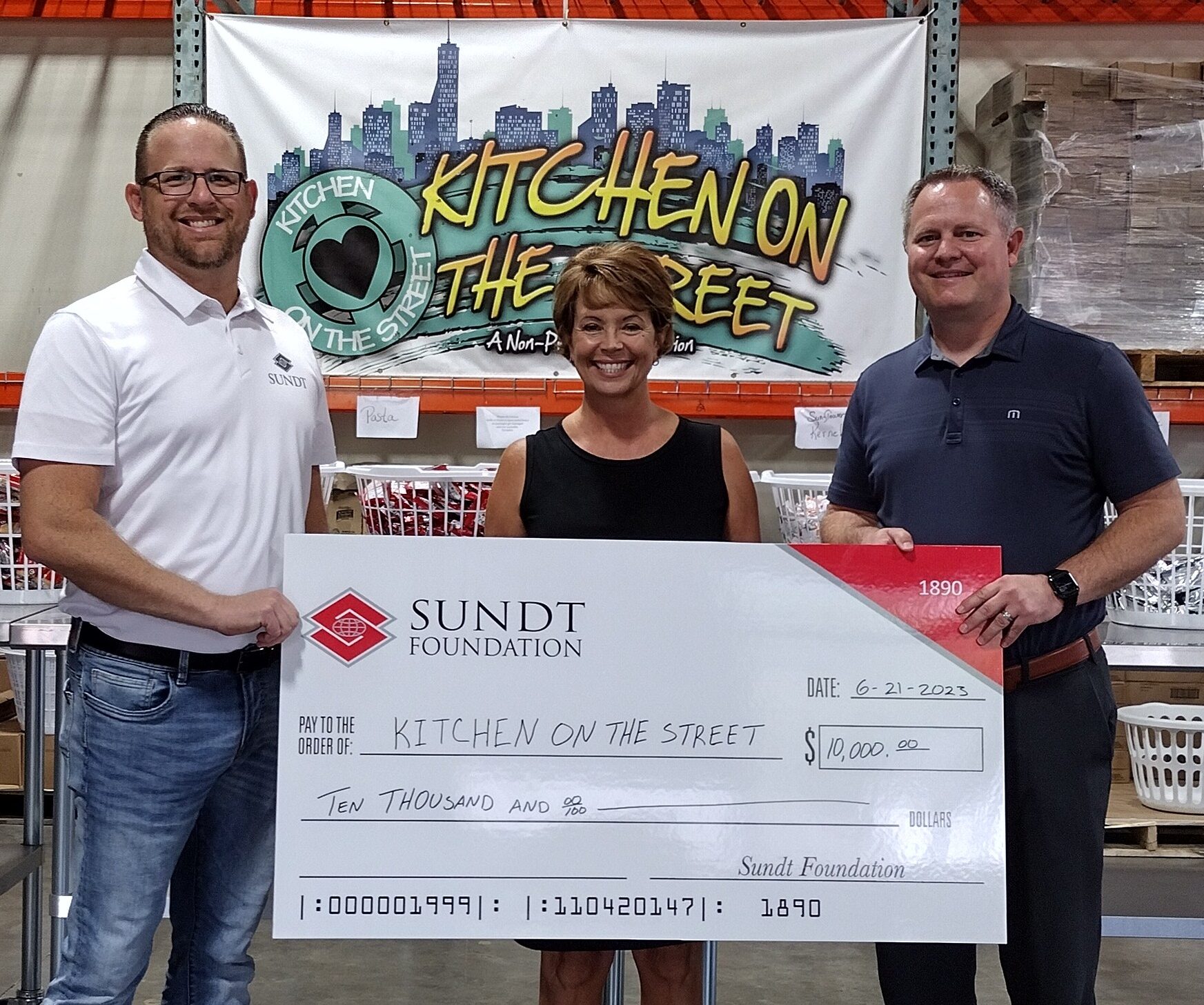 Sundt delivers a check to Kitchen on the Street